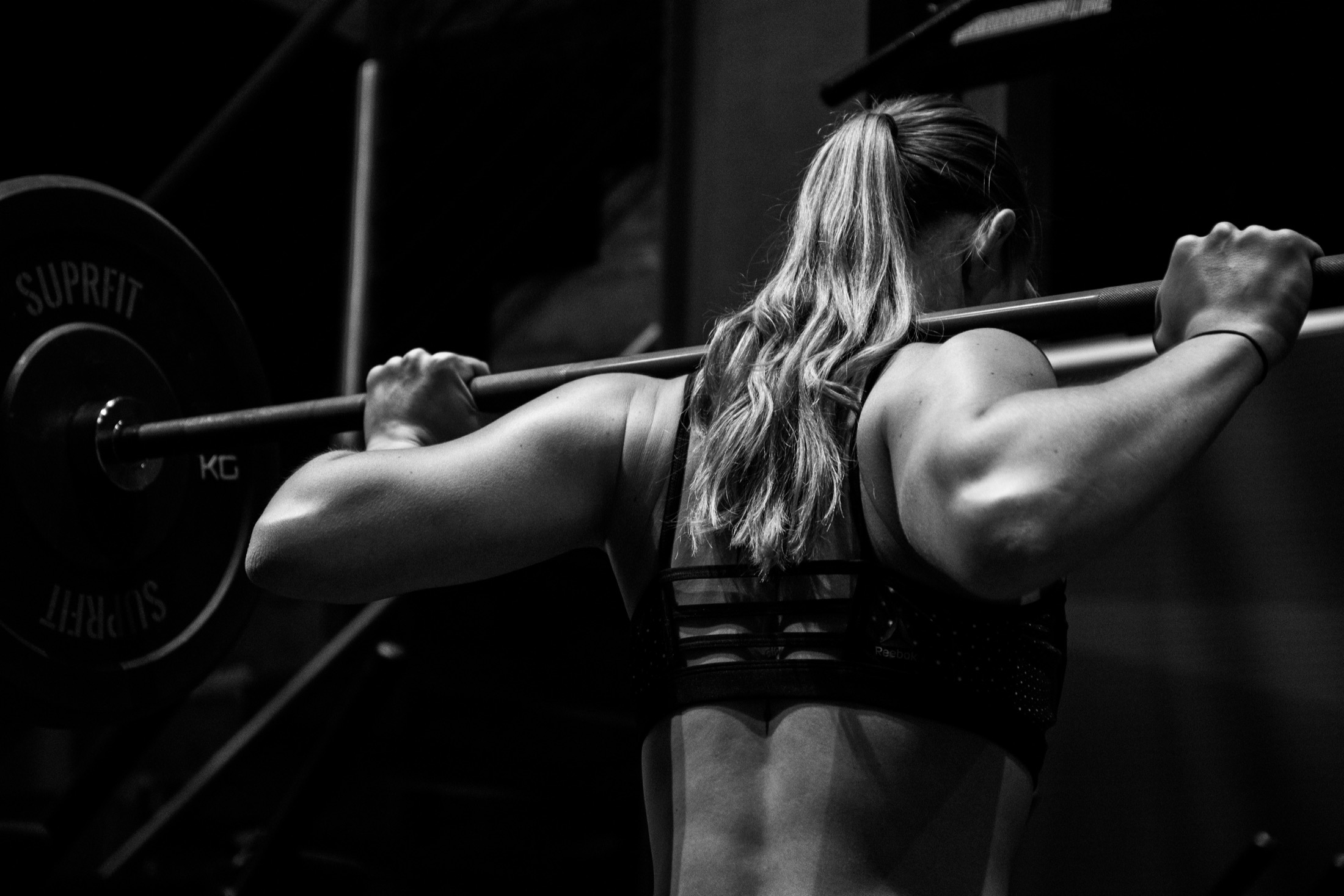 Athlete lifting a barbell across the shoulders